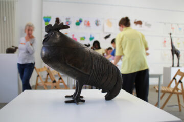 Eine Bronzeskulptur eines Hahns in der Galerie im Atelierhaus Roter Hahn. Die Bronze ist vom Bildhauer Gerhard Marcks